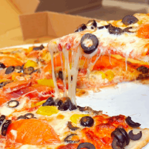 A slice of pizza with melted cheese being lifted.