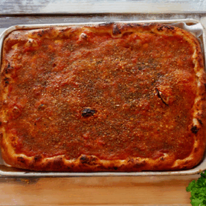 A freshly baked rectangular lasagna with a golden-brown crust.