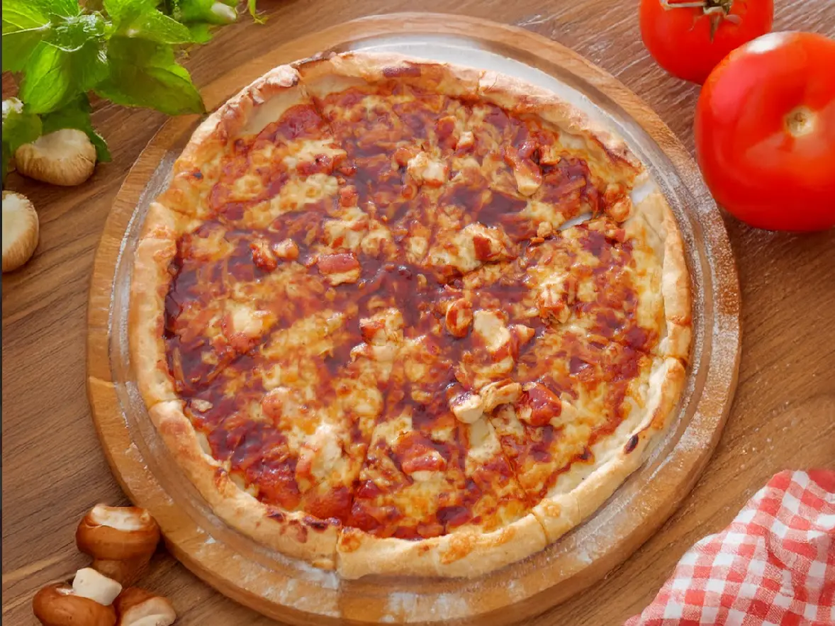 A freshly baked pizza with a golden crust on a wooden board.